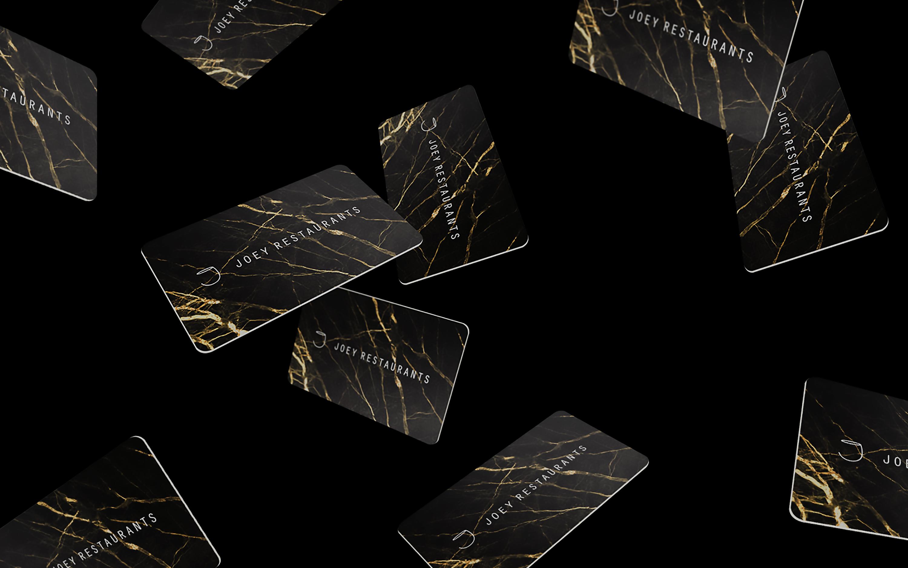 Assortment of Joey marble gift cards with a black background.